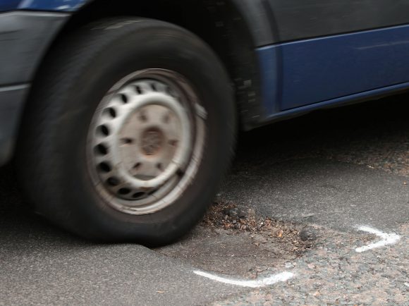 Pothole and car stock image via PA